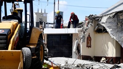 Rescuers and members of Civil Protection work amid the rubble after the roof of a church came crashing down on a baptism in Ciudad Madero, Tamapulipas state, Mexico. (AFP)