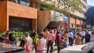 People gather outside their offices after tremors were felt due to an earthquake in New Delhi on Tuesday. (PTI) People gather outside their offices after tremors were felt due to an earthquake in New Delhi on Tuesday. (PTI)