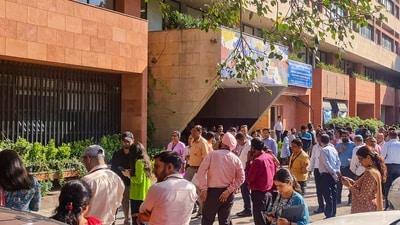 People gather outside their offices after tremors were felt due to an earthquake, in New Delhi, Tuesday. (PTI) People gather outside their offices after tremors were felt due to an earthquake, in New Delhi, Tuesday. (PTI)