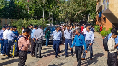 People gather outside their offices after tremors were felt due to an earthquake, in New Delhi. (PTI) People gather outside their offices after tremors were felt due to an earthquake, in New Delhi. (PTI)