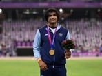 Gold medallist Neeraj Chopra celebrates on the podium during the medal ceremony for the men's javelin throw final during the 2022 Asian Games in Hangzhou(AFP)