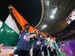 Members of India's team react after winning the Men's 4X400 relay final