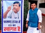 AAP MP Sanjay Singh poses next to a poster put up at his residence, in New Delhi, Wednesday, Oct. 4, 2023. ED on Wednesday morning conducted a raid at his residence. 