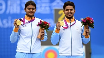 Gold medallists Jyothi Surekha Vennam and Ojas Pravin Deotale pose during the medals ceremony for the archery compound mixed team event at the 2022 Asian Games (AFP)