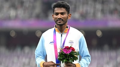 Silver medallist Avinash Mukund Sable celebrates on the podium during the medal ceremony for the men's 5,000m final athletics event during the 2022 Asian Games in Hangzhou (AFP)