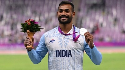 Silver medallist Kishore Jena celebrates on the podium during the medal ceremony for the men's javelin throw final event during the 2022 Asian Games (AFP)