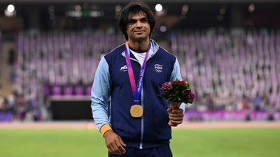 Gold medallist Neeraj Chopra celebrates on the podium during the medal ceremony for the men's javelin throw final during the 2022 Asian Games in Hangzhou (AFP)