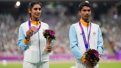 Bronze medalist Majnu Rani and Ram Baboo celebrates during the victory ceremony for the 35-kilometer race walk mixed team at the 19th Asian Games (AP)
