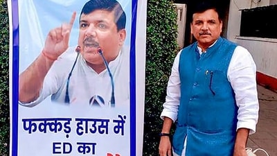 AAP MP Sanjay Singh poses next to a poster put up at his residence, in New Delhi, Wednesday, Oct. 4, 2023. ED on Wednesday morning conducted a raid at his residence. (PTI) AAP MP Sanjay Singh poses next to a poster put up at his residence, in New Delhi, Wednesday, Oct. 4, 2023. ED on Wednesday morning conducted a raid at his residence. (PTI)