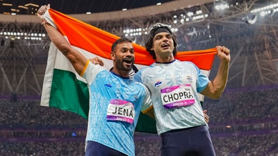 Neeraj Chopra and Kishore Kumar Jena wave the national flag in celebration after securing gold and silver medal respectively in the Men's Javelin Throw Final event at the 19th Asian Games (PTI) Neeraj Chopra and Kishore Kumar Jena wave the national flag in celebration after securing gold and silver medal respectively in the Men's Javelin Throw Final event at the 19th Asian Games (PTI)