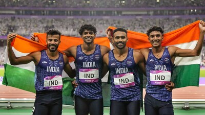 Rajesh Ramesh, Muhammed Ajmal Variyathodi, Amoj Jacob and Muhammed Anas Yahiya wave the national flag after securing gold medal in Men's 4X400m Relay Final event at the 19th Asian Games (PTI)