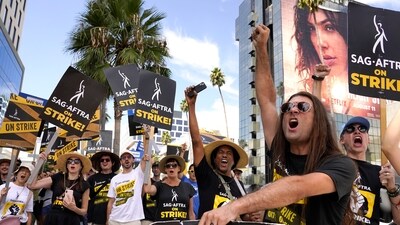 SAG-AFTRA member John Schmitt, second from right, and others carry signs on the picket line outside Netflix on Sept. 27, 2023. (Chris Pizzello/Invision/AP) SAG-AFTRA member John Schmitt, second from right, and others carry signs on the picket line outside Netflix on Sept. 27, 2023. (Chris Pizzello/Invision/AP)