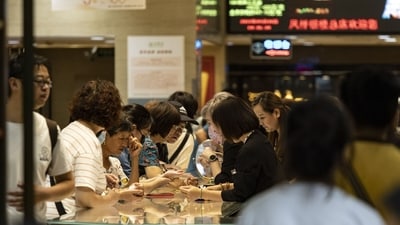 Customers at a gold and jewelry store located on Nanjing East Road, one of the city's main commercial and tourist area. (Bloomberg) Customers at a gold and jewelry store located on Nanjing East Road, one of the city's main commercial and tourist area. (Bloomberg)