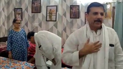 Screengrab of video in which Sanjay Singh sought blessings from his mother. (Twitter) Screengrab of video in which Sanjay Singh sought blessings from his mother. (Twitter)