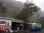 A fallen tree branch is pictured on the roof of a structure after Typhoon Koinu passed the southern tip of Taiwan on October 5.(Reuters)