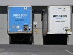 Freight semi trailers are docked at the Amazon warehouse in Palmdale, California. Freight semi trailers are docked at the Amazon warehouse in Palmdale, California.