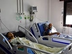 Injured individuals from the drone attack targeting a Syrian military academy receiving medical treatment at a hospital in government-controlled Homs. 