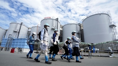 Journalists are guided along near tanks containing treated radioactive wastewater in Okuma town, northeastern Japan. (Reuters)