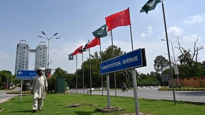A man walks past China's and Pakistani national flags installed on the constitution avenue ahead of the visit of Chinese Vice Premier He Lifeng, in Islamabad on July 30, 2023. (AFP) A man walks past China's and Pakistani national flags installed on the constitution avenue ahead of the visit of Chinese Vice Premier He Lifeng, in Islamabad on July 30, 2023. (AFP)