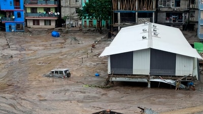 A vehicle is seen partially submerged in water after flash floods triggered by a sudden heavy rainfall swamped the Rangpo town in Sikkim, India (PTI) A vehicle is seen partially submerged in water after flash floods triggered by a sudden heavy rainfall swamped the Rangpo town in Sikkim, India (PTI)