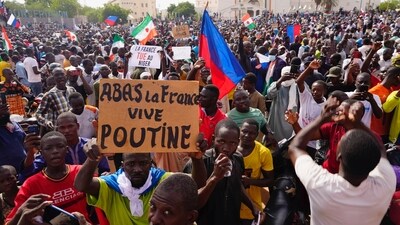 FILE - Nigeriens participate in a march called by supporters of coup leader Gen. Abdourahmane Tchiani in Niamey, Niger, Sunday, July 30, 2023. The French troops being forced out of Niger were seen as a key line of decadelong defense amid efforts led by the West, particularly U.S. and France, to fight against jihadi violence in Africa’s hard-hit Sahel region. The sign reads: "Down with France, long live Putin." (AP Photo/Sam Mednick, File) (AP)