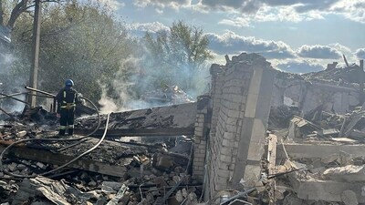 Firefighters work to extinguish a fire after the deadly Russian rocket attack that killed more than 40 people in the village of Hroza near Kharkiv, Ukraine. (AP)