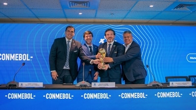 Paraguay's Soccer Association President Robert Harrison, Uruguay's Soccer Association President Ignacio Alonso, Conmebol President Alejandro Dominguez, and Conmebol Vice President Claudio Tapia poses for a photo with the World Cup trophy FIFA, in Luque, Paraguay (via REUTERS)