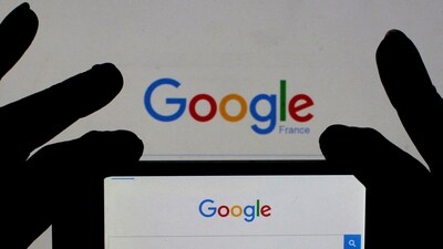 A woman holds her smart phone which displays the Google home page, in this picture illustration (REUTERS)