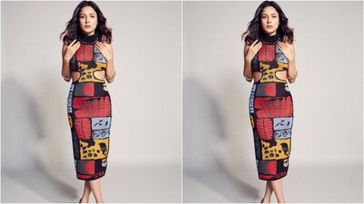 Shehnaaz dress features a black turtle neckline, a bodycon fit, a cut-out pattern at the waist, a midi hemline and an abstract muti-coloured pattern adorned all over her dress. (Instagram/@shehnaazgill)