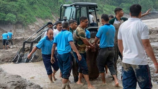 Rescue work continues after flash floods triggered by a sudden heavy rainfall swamped the Rangpo town in Sikkim on Thursday. Rescue work continues after flash floods triggered by a sudden heavy rainfall swamped the Rangpo town in Sikkim on Thursday.