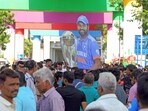 A cutout of Indian skipper Rohit Sharma holding the World Cup trophy is seen as fans gather outside Narendra Modi Stadium in Ahmedabad.