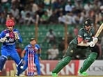 Shakib Al Hasan (R) plays a shot as Afghanistan's wicketkeeper Rahmanullah Gurbaz (L) looks on Shakib Al Hasan (R) plays a shot as Afghanistan's wicketkeeper Rahmanullah Gurbaz (L) looks on