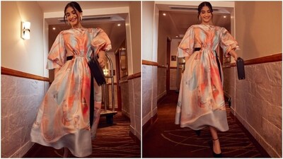 Her dress features balloon sleeves in a flowy silk fabric adorned all over with a marbled painterly pattern. The addition of the black belt at the sides, which sat elegantly against the pastel silk midi dress, added an extra touch of glamour. (Instagram/@sonamkapoor) Her dress features balloon sleeves in a flowy silk fabric adorned all over with a marbled painterly pattern. The addition of the black belt at the sides, which sat elegantly against the pastel silk midi dress, added an extra touch of glamour. (Instagram/@sonamkapoor)