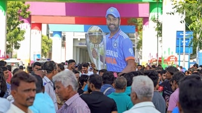 A cutout of Indian skipper Rohit Sharma holding the World Cup trophy is seen as fans gather outside Narendra Modi Stadium in Ahmedabad. (ANI  )