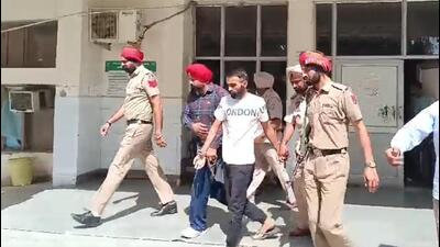 Punjab Police personnel escorting gangster Sachin Bishnoi out of the Mansa court complex on Friday. (HT Photo) Punjab Police personnel escorting gangster Sachin Bishnoi out of the Mansa court complex on Friday. (HT Photo)