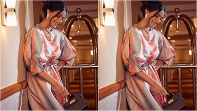 Sonam styled her look with a pair of white geometric statement earrings, black strappy heels and a bronze mini handbag to complete her stylish look. (Instagram/@sonamkapoor) Sonam styled her look with a pair of white geometric statement earrings, black strappy heels and a bronze mini handbag to complete her stylish look. (Instagram/@sonamkapoor)