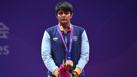 Sonam stands on the podium during the award ceremony of the women's 62kg freestyle wrestling event during the Asian Games in Hangzhou(AFP)