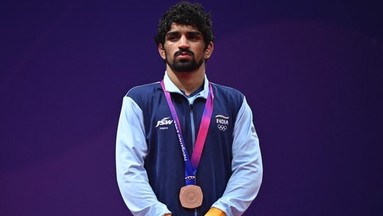 India's Aman poses with his bronze medal during the award ceremony for the men's 57 kg freestyle wrestling match at the Asian Games in Hangzhou in China(AFP)