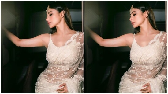 Mouni looked every bit gorgeous in the white saree with netted details and embroidery work in white threads throughout. Mouni teamed it with a matching white sleeveless blouse.&nbsp;(Instagram/@imouniroy)