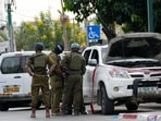 Israel-Palestine Latest: Israeli soldiers stand by a pickup truck used by Palestinian militants in Sderot, Israel. Israel-Palestine Latest: Israeli soldiers stand by a pickup truck used by Palestinian militants in Sderot, Israel.