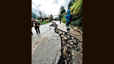 A road damaged due to flash floods triggered by heavy rainfall in Mangan district. (PTI) A road damaged due to flash floods triggered by heavy rainfall in Mangan district. (PTI)