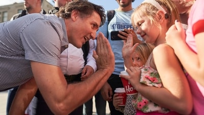 Prime Minister Justin Trudeau gets a high-five from a child during a stop in downtown Kitchener, Ontario, for the start of Oktoberfest on Friday, (AP) Prime Minister Justin Trudeau gets a high-five from a child during a stop in downtown Kitchener, Ontario, for the start of Oktoberfest on Friday, (AP)