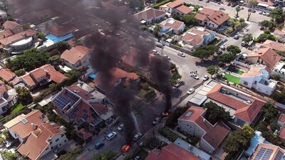 Israel-Palestine Latest: An aerial view shows vehicles on fire as rockets are launched from the Gaza Strip, in Ashkelon, southern Israel. (Reuters)