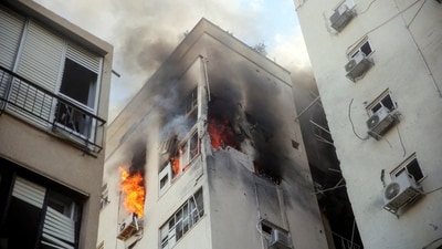 A building is ablaze following rocket attacks from the Gaza Strip, in Tel Aviv, Israel (REUTERS)