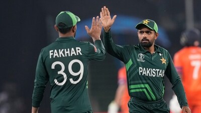 Pakistan's captain Babar Azam, right, and Fakhar Zaman celebrates the dismissal of Netherlands' Vikram Singh during the ICC Men's Cricket World Cup match (AP) Pakistan's captain Babar Azam, right, and Fakhar Zaman celebrates the dismissal of Netherlands' Vikram Singh during the ICC Men's Cricket World Cup match (AP)
