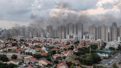Smoke rises after a rocket fired from the Gaza Strip hit a house in Ashkelon, southern Israel, Saturday, Oct. 7, 2023. (AP) Smoke rises after a rocket fired from the Gaza Strip hit a house in Ashkelon, southern Israel, Saturday, Oct. 7, 2023. (AP)