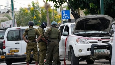 Israel-Palestine Latest: Israeli soldiers stand by a pickup truck used by Palestinian militants in Sderot, Israel. (AP) Israel-Palestine Latest: Israeli soldiers stand by a pickup truck used by Palestinian militants in Sderot, Israel. (AP)