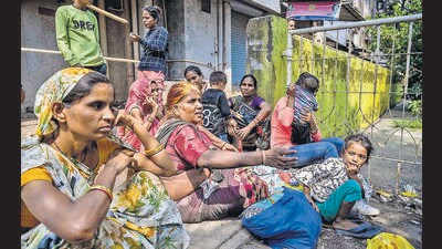Mumbai, India - Oct. 7, 2023: Residents of the Goregaon's SRA building sitting out side the building, where 7 dead, 62 injured in massive building fire in Mumbai, India, on Saturday, October 7, 2023. (Photo by Satish Bate/ Hindustan Times) (Hindustan Times) Mumbai, India - Oct. 7, 2023: Residents of the Goregaon's SRA building sitting out side the building, where 7 dead, 62 injured in massive building fire in Mumbai, India, on Saturday, October 7, 2023. (Photo by Satish Bate/ Hindustan Times) (Hindustan Times)