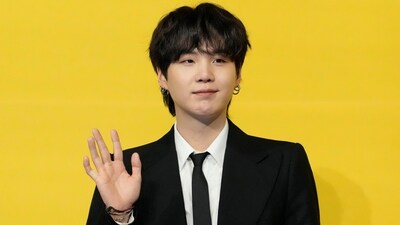 FILE - Suga, a member of South Korean K-pop band BTS, poses for photographers ahead of a press conference to introduce their new single "Butter" in Seoul, South Korea on May 21, 2021. (AP Photo/Lee Jin-man, File) (AP)