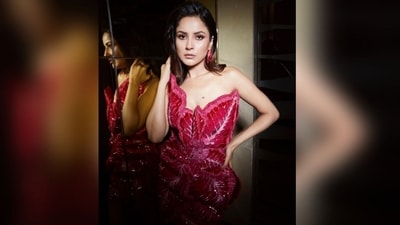 Shehnaaz's strapless mini dress comes in a captivating bright pink shade and features an intricate floral pattern that mimics the details of the iris flower. The sheer detailing at the back and the shiny fabric added an extra glam touch to her outfit, making it a complete showstopper. (Instagram/@shehnaazgill) Shehnaaz's strapless mini dress comes in a captivating bright pink shade and features an intricate floral pattern that mimics the details of the iris flower. The sheer detailing at the back and the shiny fabric added an extra glam touch to her outfit, making it a complete showstopper. (Instagram/@shehnaazgill)